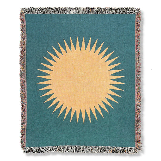 Front product image of teal with orange sun woven throw blanket titled Cardiff.